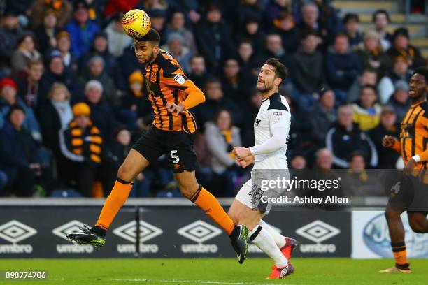 Michael Hector of Hull City heads the ball as David Nugent of Derby County looks on during the Sky Bet Championship match between Hull City and Derby...