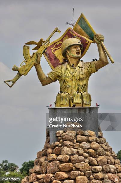 Victory Monument in Puthukkudiyiruppu, Northern Province, Sri Lanka. This monument depicts a Sri Lankan Army solider waving a flag in one hand and...