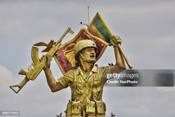 Victory Monument in Puthukkudiyiruppu, Northern Province, Sri Lanka. This monument depicts a Sri Lankan Army solider waving a flag in one hand and...