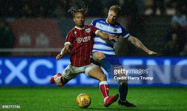 Bobby Reid of Bristol City is tackled by Paul McShane of Reading during the Sky Bet Championship match between Bristol City and Reading at Ashton...