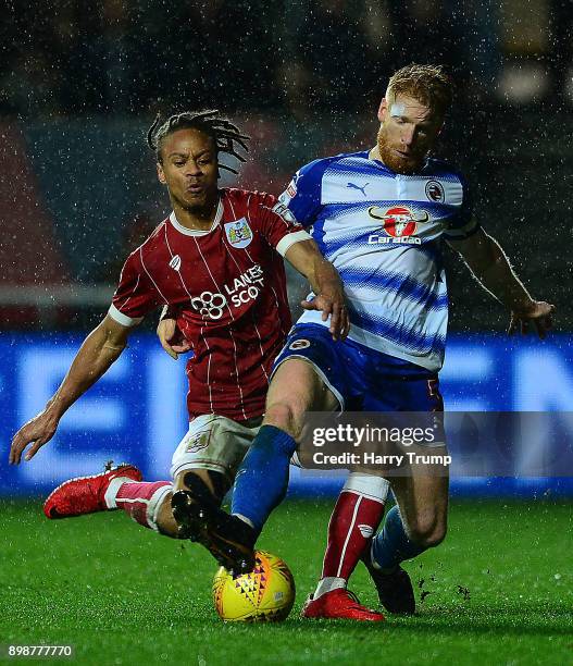 Bobby Reid of Bristol City is tackled by Paul McShane of Reading during the Sky Bet Championship match between Bristol City and Reading at Ashton...