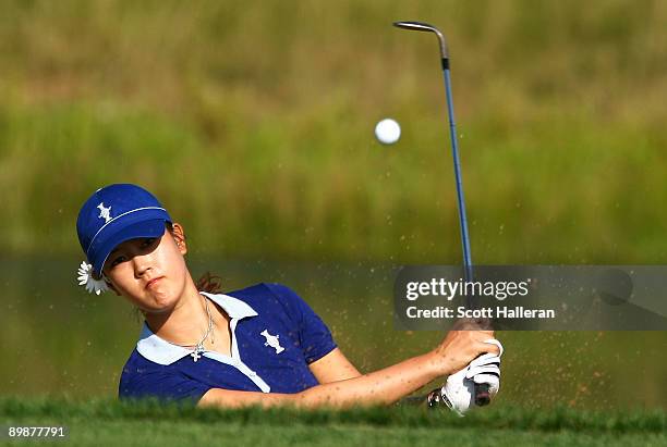 Michelle Wie of the U.S. Team hits a bunker shot during a practice round prior to the start of the 2009 Solheim Cup at Rich Harvest Farms on August...