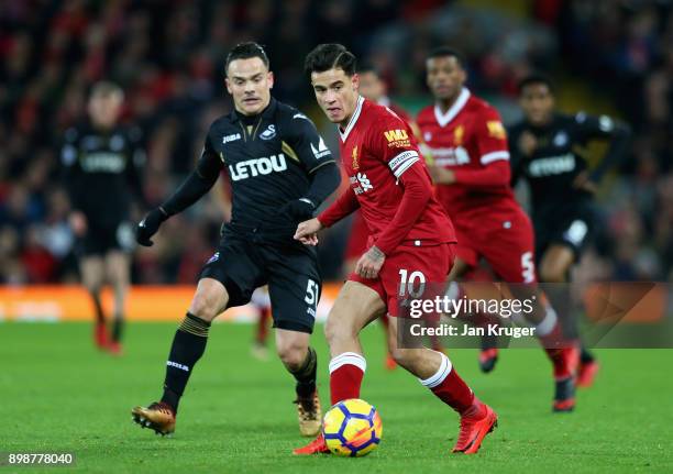 Philippe Coutinho of Liverpool is closed down by Roque Mesa of Swansea City during the Premier League match between Liverpool and Swansea City at...