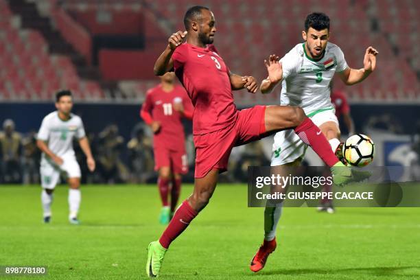 Qatar's defender Abdelkarim Hassan vies for the ball against Iraq's Ayman Hussein Ghadhban during their 2017 Gulf Cup of Nations group match at Al...