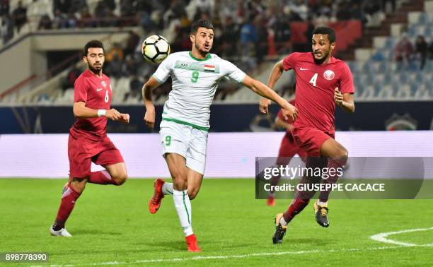 Qatar's defender Al-Mahdi Ali Mukhtar vies for the ball against Iraq's Ayman Hussein Ghadhban during their 2017 Gulf Cup of Nations group match at Al...