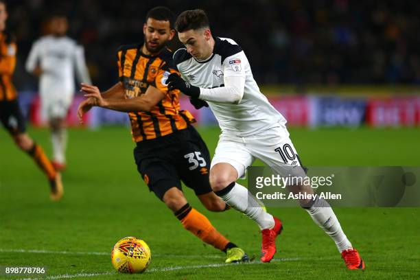 Tom Lawrence of Derby County runs with the ball pursued by Kevin Stewart of Hull City during the Sky Bet Championship match between Hull City and...