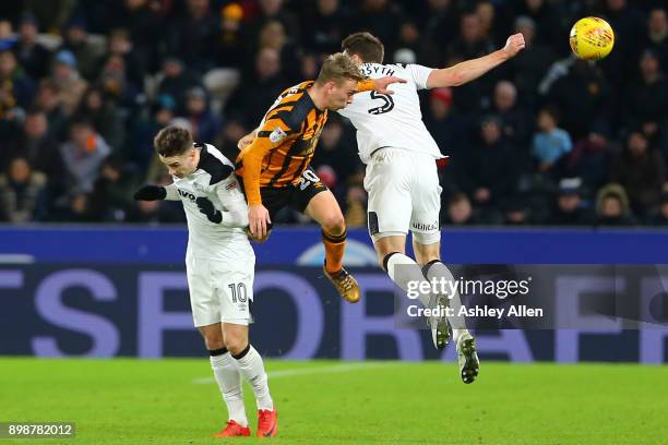 Jarrod Bowen of Hull City wins the ball from Derby County's Tom Lawrence and Craig Forsyth during the Sky Bet Championship match between Hull City...