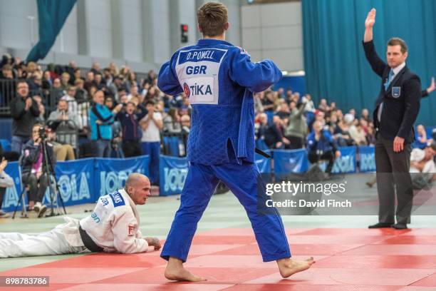 Referee, Archie Shrimpton, signals ippon while Daniel Powell of the West Midlands victoriously struts the mats following his 'knock-out' throw of...