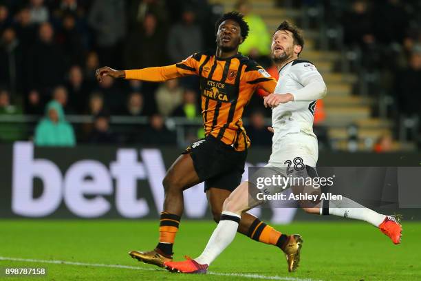 Ola Aina of Hull City and David Nugent of Derby County keep their eyes on the ball as it is crossed into the box during the Sky Bet Championship...