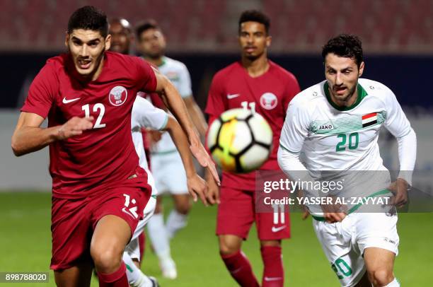 Qatar's midfielder Karim Boudiaf runs towards the ball as he vies against Iraq's defender Rebin Sulaka during their 2017 Gulf Cup of Nations group...