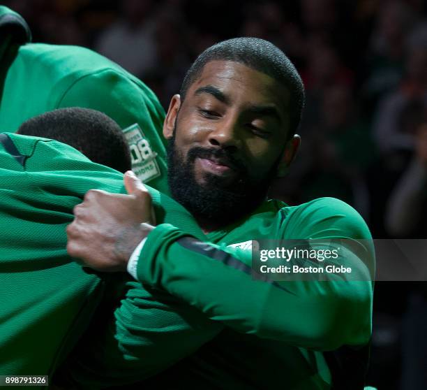Boston Celtics' Kyrie Irving playfully bumps teammates after pregame introductions at TD Garden in Boston on Dec. 6, 2017. As they strive for an 18th...