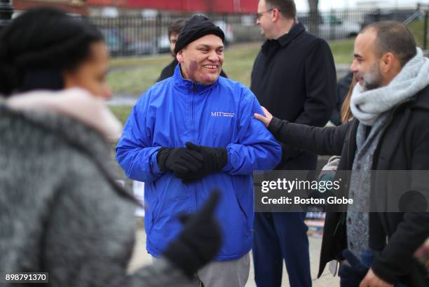 Formerly detained MIT janitor Francisco Rodriguez smiles as he is greeted by supporters as he arrives at Bellingham Park in Chelsea, MA to speak to...