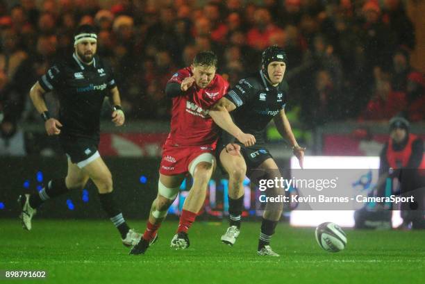 Scarlets' James Davies battles with Ospreys' Ben John during the Guinness Pro14 Round 11 match between Scarlets and Ospreys at Parc y Scarlets on...