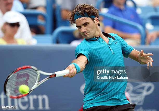 Roger Federer of Switzerland hits a forehand against Jose Acasuso of Argentina during day three of the Western & Southern Financial Group Masters on...