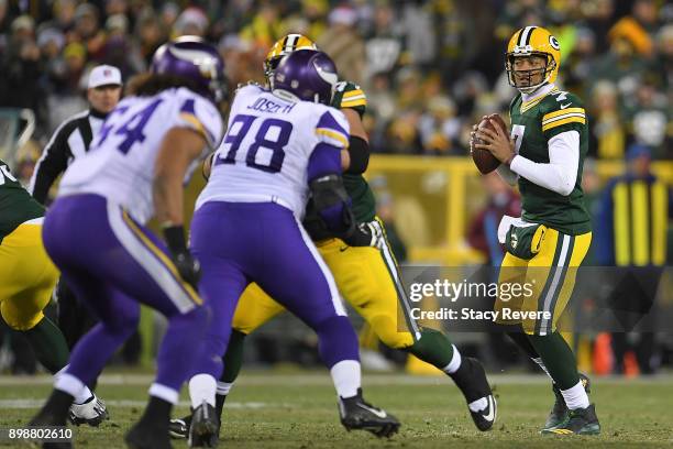 Brett Hundley of the Green Bay Packers drops back to pass during a game against the Minnesota Vikings at Lambeau Field on December 23, 2017 in Green...