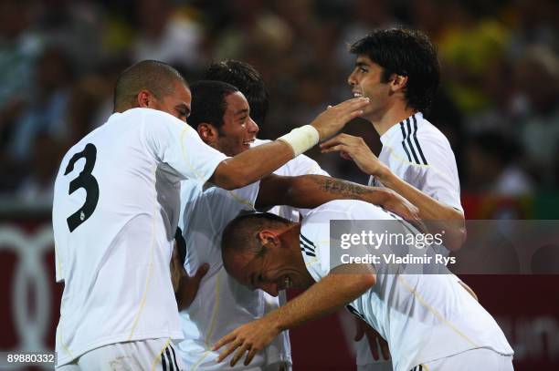 Arjen Robben of Madrid is celebrated by his team mates after scoring his team's second goal during a friendly match between Borussia Dortmund and...