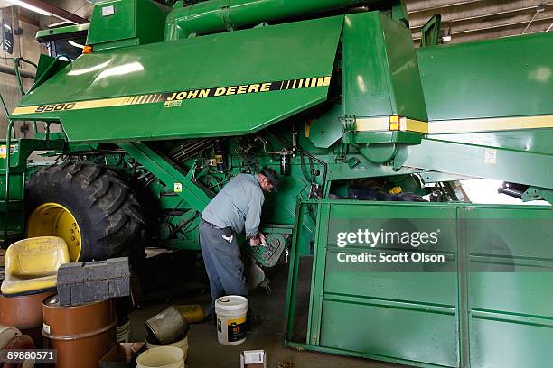 Don Heine works on a customer's John Deere combine at the Buck Bros. Dealership August 19, 2009 in Hampshire, Illinois. Deere & Co., the world�s...