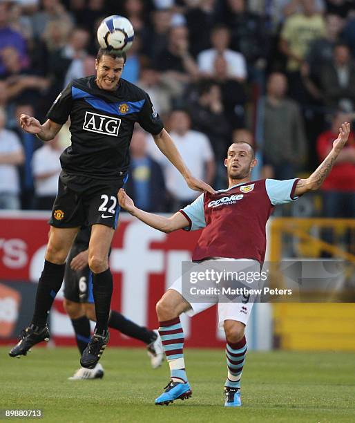 John O'Shea of Manchester United clashes with Steven Fletcher of Burnley during the FA Barclays Premier League match between Burnley and Manchester...