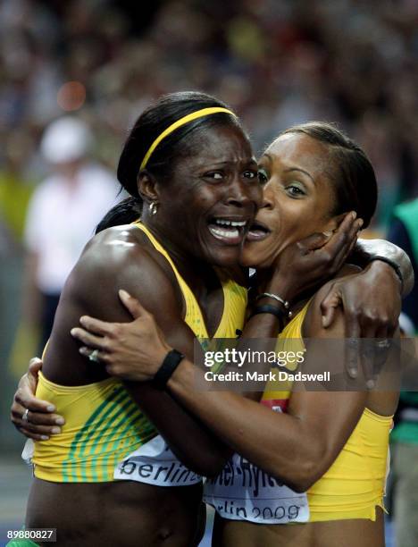 Brigitte Foster-Hylton of Jamaica celebrates winning the gold medal and Delloreen Ennis-London of Jamaica celebrates winning the bronze medal in the...