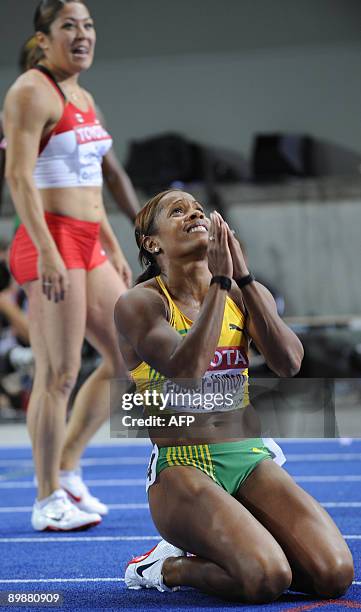 Jamaica's Brigitte Foster-Hylton celebrates her first place in the women's 100m hurdles final race of the 2009 IAAF Athletics World Championships on...