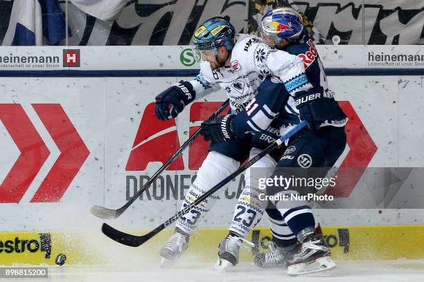 Jakob Mayenschein of Red Bull Munich vies Matt Pelech of ERC Ingolstadt during 35th Gameday of German Ice Hockey League between Red Bull Munich and...