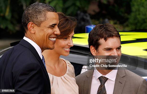 President Barack Obama poses for a photograph with NASCAR driver Jeff Gordon and his wife Ingrid Vandebosch during an event honoring the 2008 Sprint...