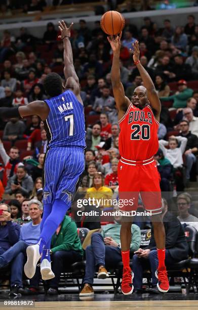 Quincy Pondexter of the Chicago Bulls shoots against Shelvin Mack of the Orlando Magic at the United Center on December 20, 2017 in Chicago,...