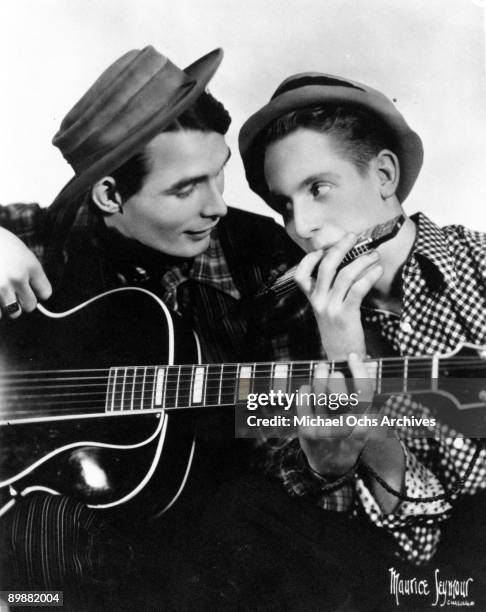 Rhubarb Red , guitarist and inventor Les Paul's hillbilly altter ego, poses for a portrait holding a harmonica in circa 1935.