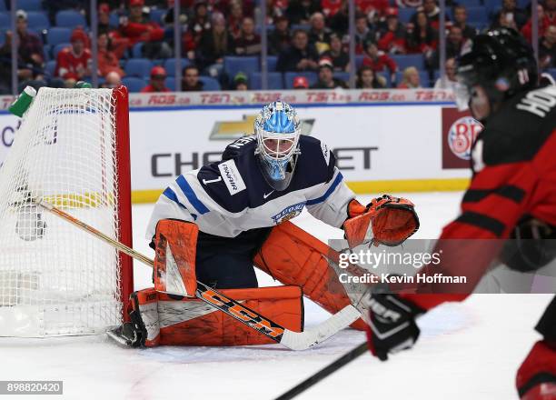 Ukko-Pekka Luukkonen of Finland tends net as Brett Howden of Canada skates by with the puck during the first period at KeyBank Center on December 26,...