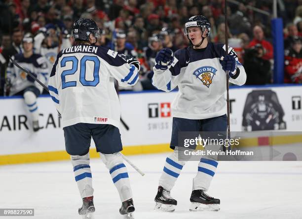 Henri Jokiharju of Finland celebrates his goal against Canada with Eeli Tolvanen during the second period at KeyBank Center on December 26, 2017 in...