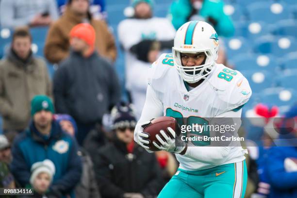 Julius Thomas of the Miami Dolphins participates in warm ups before the game against the Buffalo Bills at New Era Field on December 17, 2017 in...