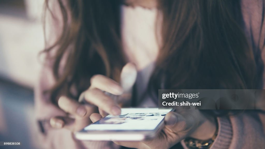Woman use of mobile phone at street
