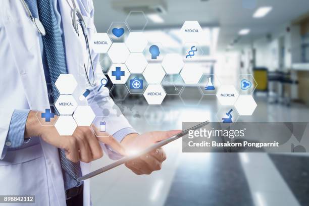 healthcare and medicine. doctor using a digital tablet computer at work - press screening stock pictures, royalty-free photos & images