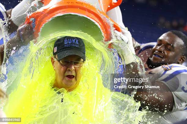 Head coach David Cutcliffe of the Duke Blue Devils reacts to his Gatorade bath by Mike Ramsay and Trevon McSwain after defeating the Northern...