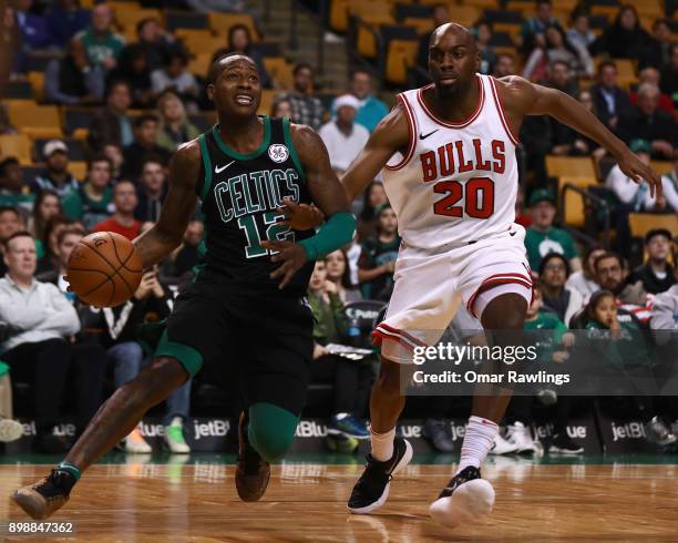 Terry Rozier of the Boston Celtics drives the basket on Quincy Pondexter of the Chicago Bulls during the game at TD Garden on December 23, 2017 in...