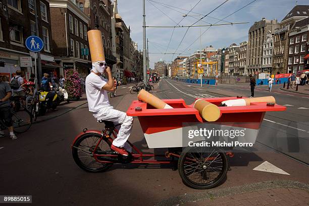 Zack Neil rides his ash tray bike in down town Amsterdam on August 19, 2009 in Amsterdam, Netherlands. Zack Neil informs inhabitants and tourists...