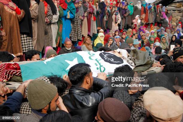 Kashmiri villagers carry the body of top militant commander Noor Mohammad Tantray during his funeral in the Aripal village of Tral district on...