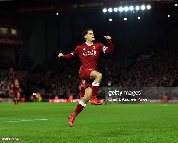 Philippe Coutinho of Liverpool celebrates after scoring the opening goal during the Premier League match between Liverpool and Swansea City at...