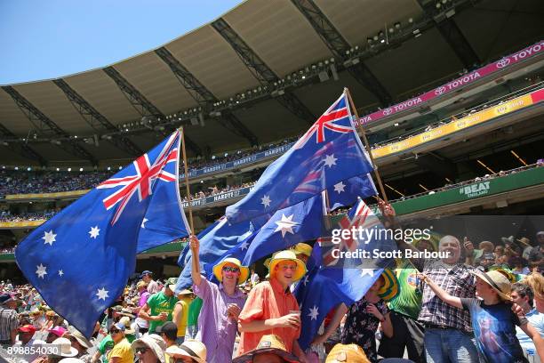 Australian cricket fans in the crowd wave Australian flags during day two of the Fourth Test Match in the 2017/18 Ashes series between Australia and...