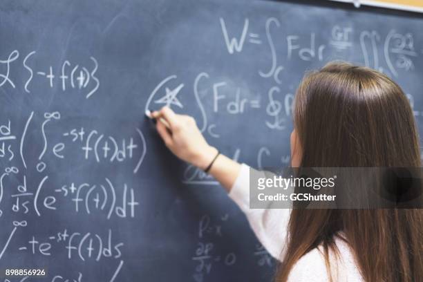 highlighting an important equation on the blackboard - mathematician stock pictures, royalty-free photos & images
