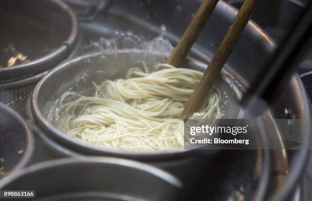 Hakata-Sanki Co. Employee boils ramen noodles at the company's restaurant in Dazaifu, Fukuoka, Japan, on Dec. 21, 2017. Fukuoka, on Japans southern...