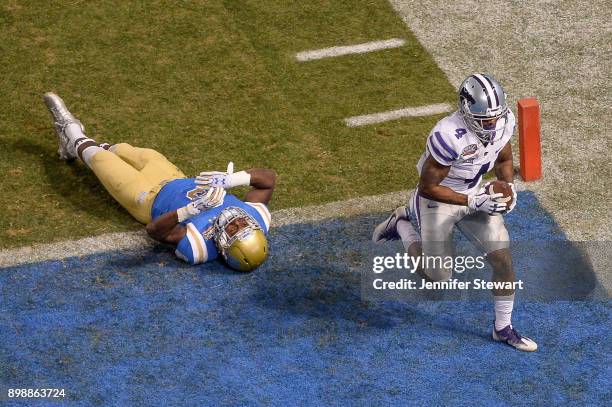 Wide receiver Dominique Heath of the Kansas State Wildcats runs in an eight yard touchdown against defensive back Adarius Pickett of the UCLA Bruins...