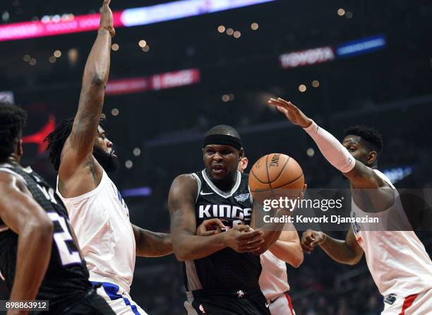 Zach Randolph of the Sacramento Kings looks for an outlet pass under pressure from DeAndre Jordan and Jamil Wilson of the Los Angeles Clippers during...