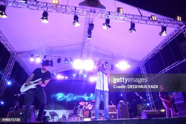 This photo taken on December 26, 2017 shows Indonesian rock band Slank performing during the Big Bang Slank Music Concert in Jakarta. / AFP PHOTO /...