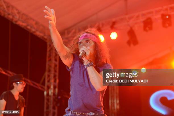This photo taken on December 26, 2017 shows Indonesian rock band Slank performing during the Big Bang Slank Music Concert in Jakarta. / AFP PHOTO /...