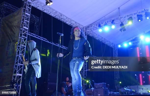 This photo taken on December 26, 2017 shows Indonesian rock band Slank performing during the Big Bang Slank Music Concert in Jakarta. / AFP PHOTO /...