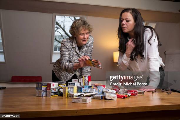 Dutch lung cancer patient Anne Marie van Veen and her criminal lawyer Benedicte Ficq look at packets of cigarettes in preparation of the first ever...