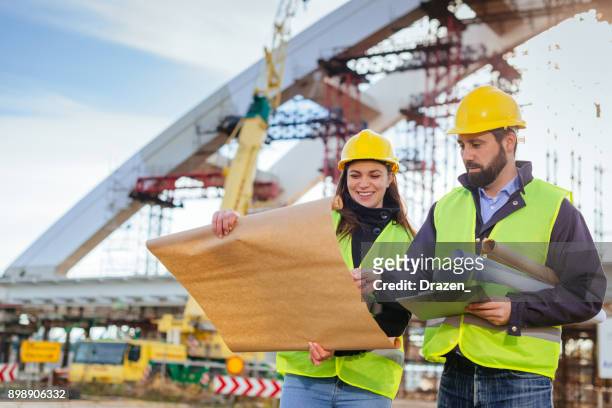 new blueprint and plans for next constuction phase - bridge built structure stock pictures, royalty-free photos & images