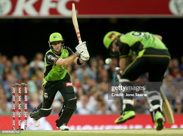 Sydney player Callum Ferguson accidentally hits team mate Ben Rohrer with his shot during the Big Bash League match between the Brisbane Heat and the...