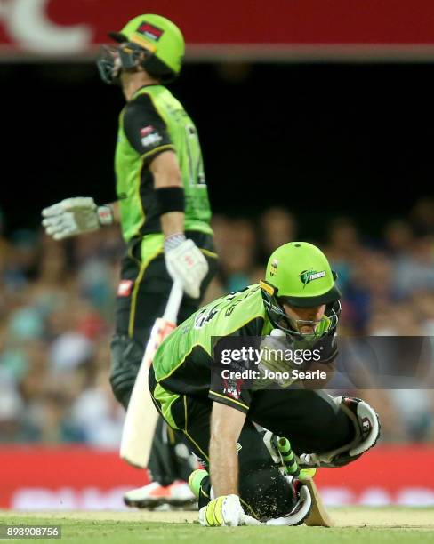 Sydney player Callum Ferguson accidentally hits team mate Ben Rohrer with his shot during the Big Bash League match between the Brisbane Heat and the...